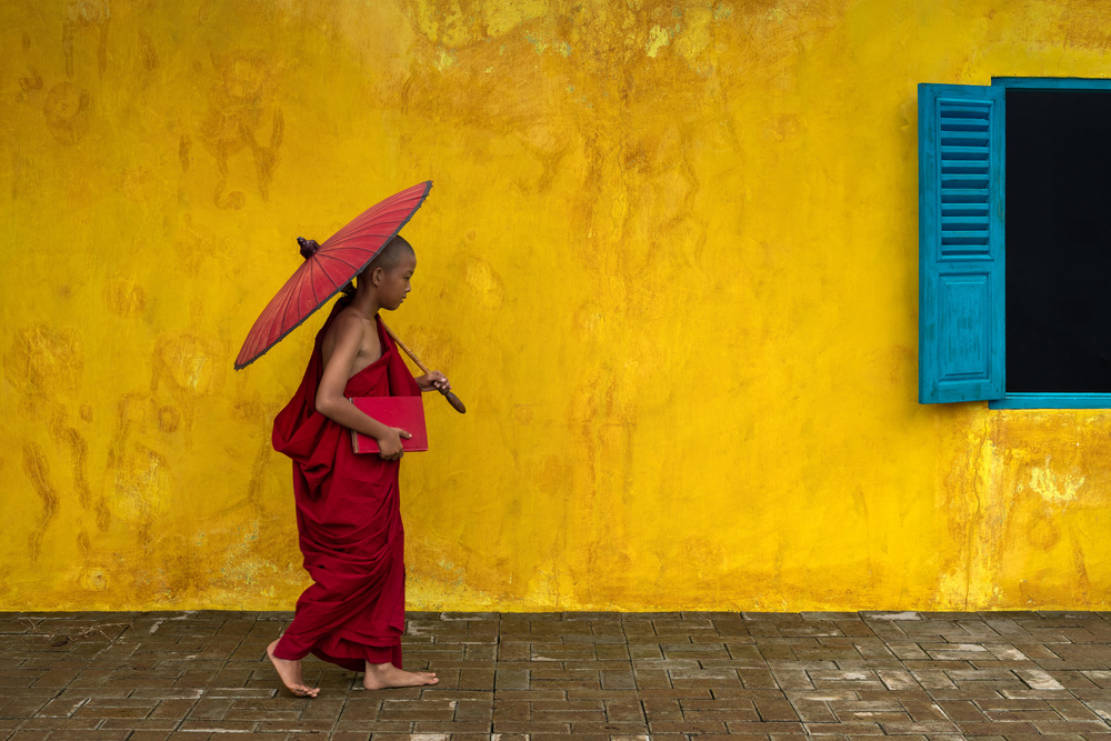 Novice monk walking by à Anges van der Logt